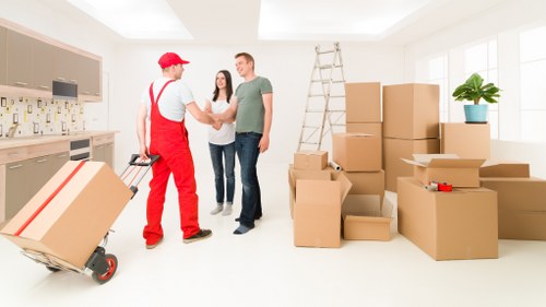 Local movers handling furniture carefully during an Ilford house move