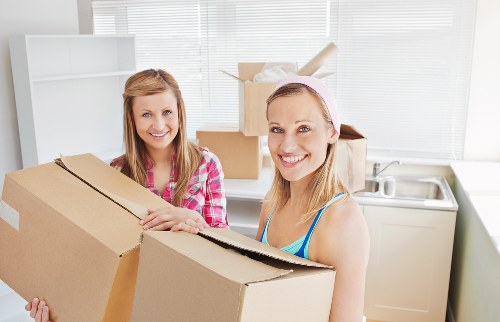 Local moving team handling boxes and furniture in Ilford
